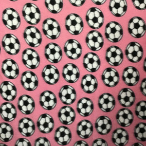 Soccer Balls on Pink Fleece Fabric